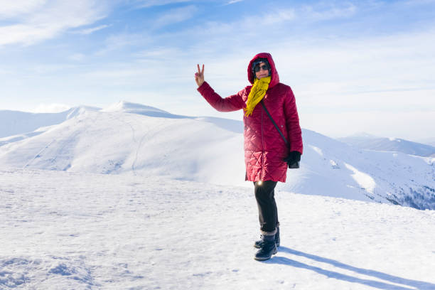 istock Woman stand on Carpathian mountain range background in winter 1154872627