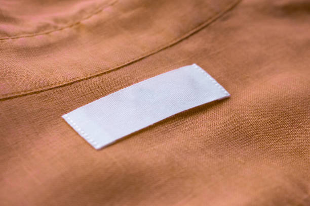 istock White blank clothing tag label on brown linen shirt fabric texture background 1154873013