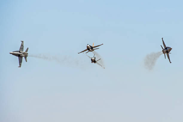 Aerobatics planes flying in the sky with clouds in the background