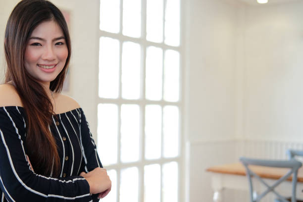 istock asian woman smiling posing at home 1154873191