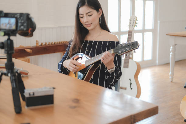 istock blogger live broadcasting music instrument tutorial on social media. vlogger recording online vlog video. 1154873194