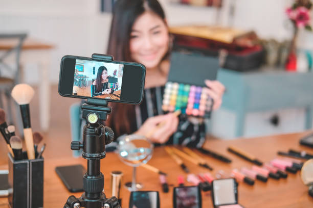 istock beauty blogger live broadcasting cosmetic makeup tutorial on social media. 1154873205