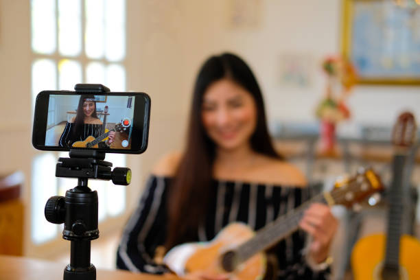 istock blogger live broadcasting music instrument tutorial on social media. vlogger recording online vlog video. 1154873219