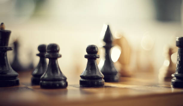 istock Wooden chess pieces on the chessboard. 1154873410
