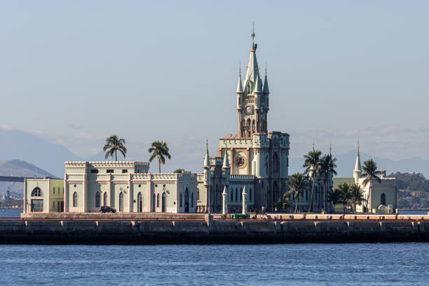 the historical building and fiscal island (ilha fiscal) in the guanabara bay attached to the naval island with military ship in the background - rio de janeiro guanabara bay urban scene cityscape imagens e fotografias de stock