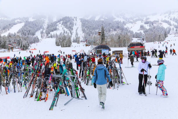 Skis on racks at the base of Jackson Hole Mountain Resort in winter snow People and skis at the base of the Jackson Hole in Jackson, Wyoming December 24, 2018 slopestyle stock pictures, royalty-free photos & images