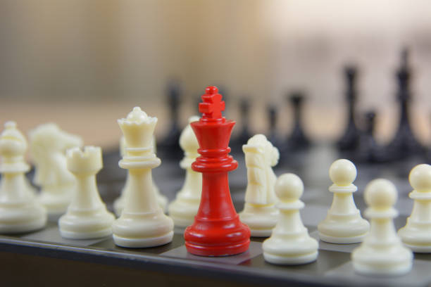 istock Red chess between black chess board game for competition and strategy, business success concept 1154884602