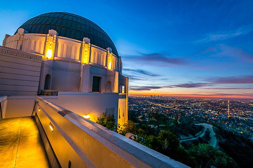 Sunrise over the iconic Griffith Park Observatory and Los Angeles skyline.