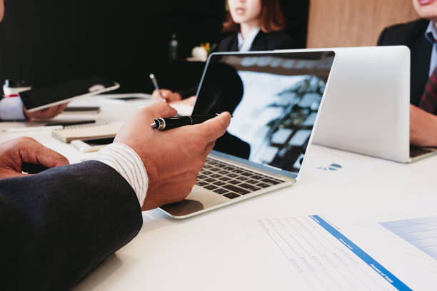 istock Business people analyzing investment graph meeting brainstorming and discussing plan in meeting room, investment concept 1154892839