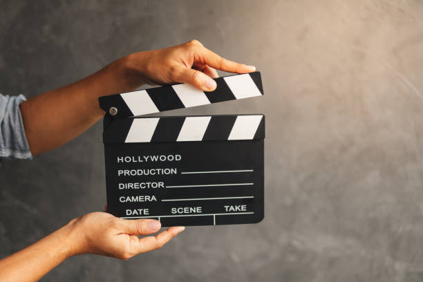 istock Women hands holding clapper board for making video cinema in studio. 1154896934