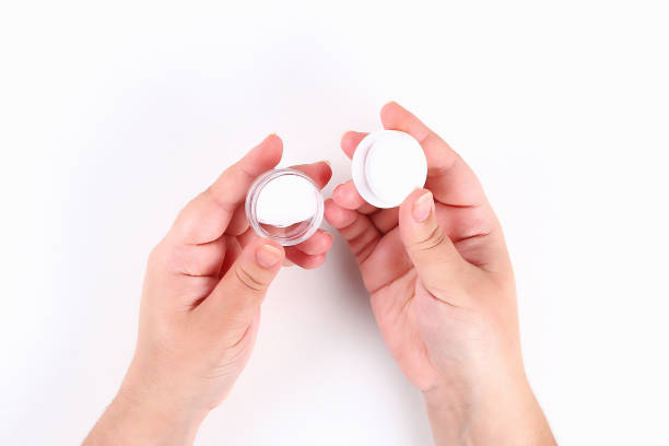 istock Girl uses hand cream on white background. Top view. 1154897132
