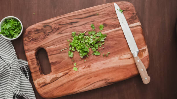 istock Slicing fresh parsley to garnish beet soup, borscht. 1154901454