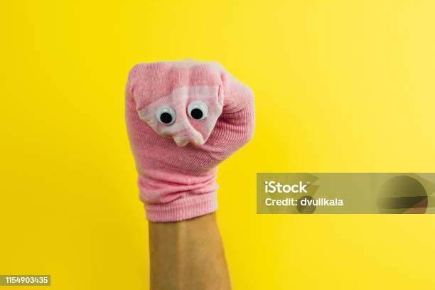Funny Doll Sock With Googly Eyes On A Yellow Background Stock Photo - Download Image Now
