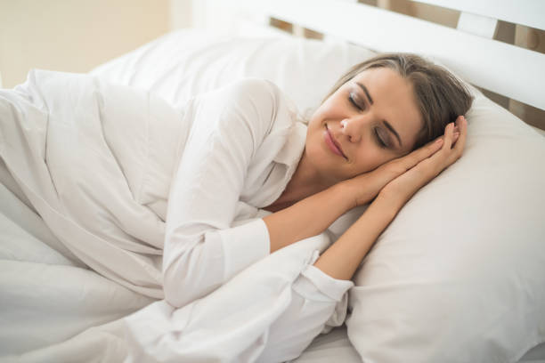 istock Beautiful Young woman sleeping in bed 1154905163