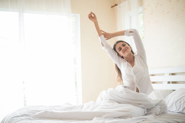 istock Lazy young woman sitting in bedroom 1154905241