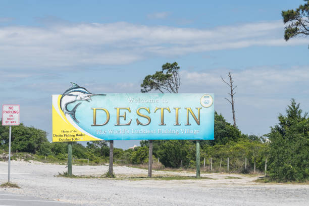Road sign, billboard with Welcome to Destin the World's luckiest fishing village in Florida Panhandle Destin, USA - April 24, 2018: Road sign, billboard with Welcome to Destin the World's luckiest fishing village in Florida Panhandle small florida home stock pictures, royalty-free photos & images