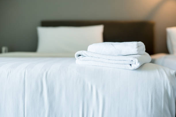 istock White hotel towel on bed,Stack of fluffy bath towels,Close up,Copy space for text 1154906851