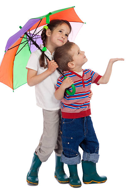 istock Little children with umbrella, looking up 115490700