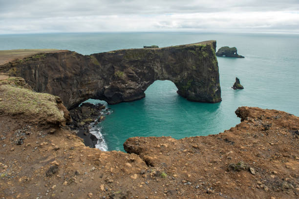 istock Dyrholaey rock arch in the Atlantic ocean, Iceland 1154910779