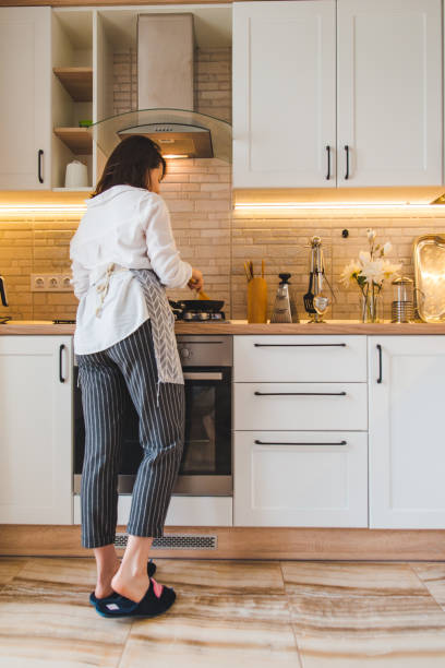 istock view from behind woman on kitchen cooking 1154912082