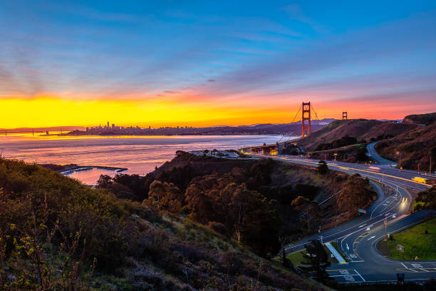 The San Francisco Bay Area Sunrise begins over the San Francisco Bay Area and the Golden Gate Bridge from the Marin Headlands. peninsula stock pictures, royalty-free photos & images