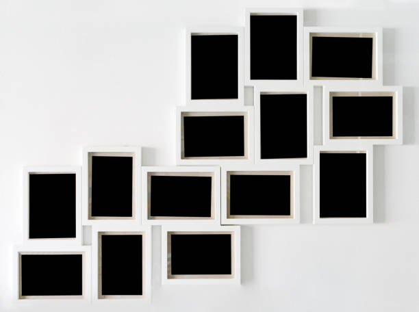 istock White picture frame and black decorative hanging on white wall 1154914505