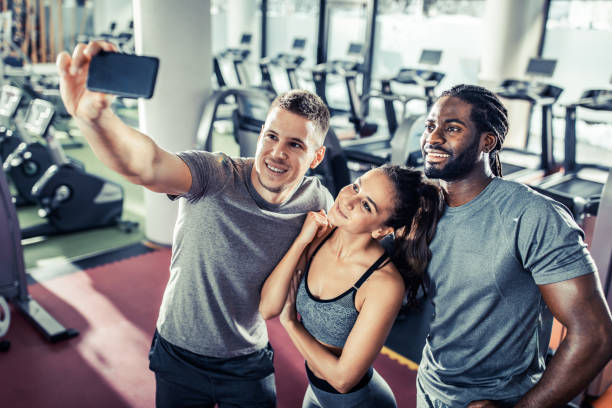 istock Happy athletic friends taking a selfie on a break in a gym. 1154914642