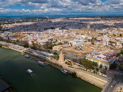 Aerial panoramic view of modern cityscape of Seville with Guadalquivir river, Spain