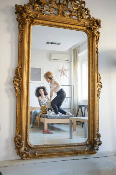 istock Reflection of two women flatmates in old-fashioned mirror 1154918086