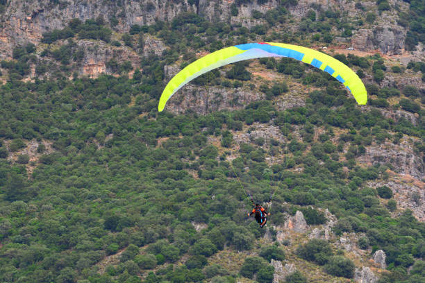 istock Skydiving sport. Paraglider fly from the beautiful mountains. 1154920698