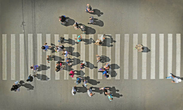 istock Aerial. People crowd on pedestrian crosswalk. Top view. 1154920780