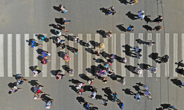 istock Aerial. People crowd on pedestrian crosswalk. Top view. 1154920831