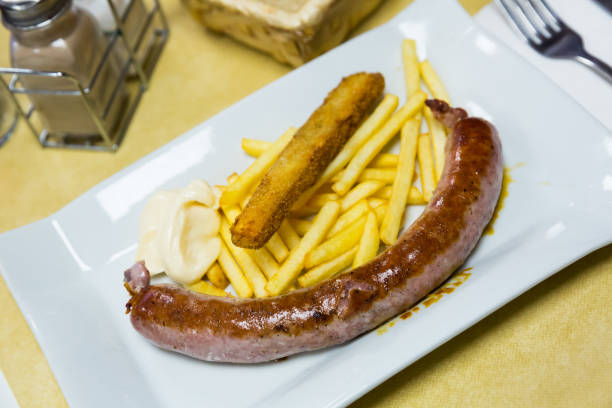 istock Rustic sausage with fried potato served at plate with sauce 1154920931