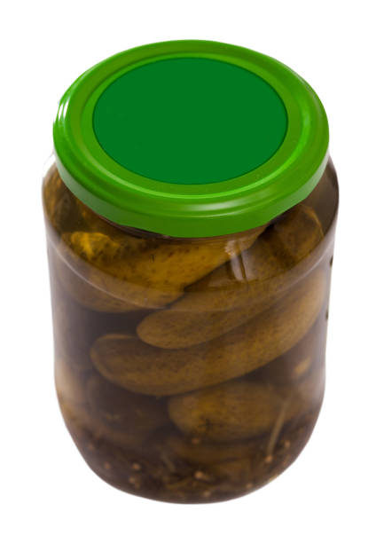 istock Glass jar with pickled cucumbers on white background 1154921005