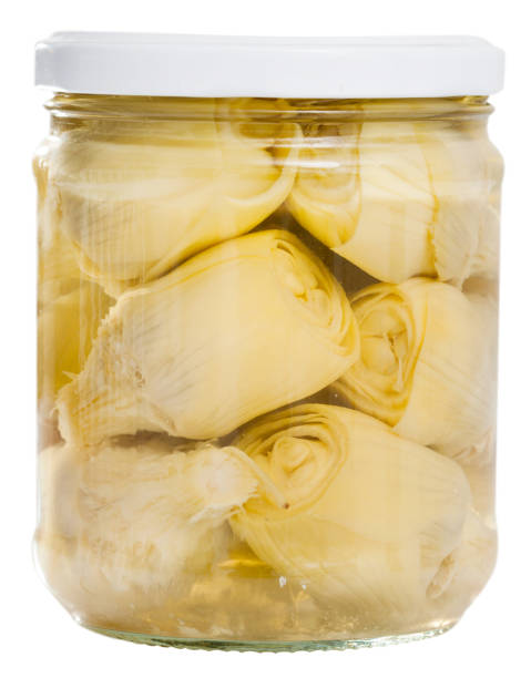 Marinated artichokes in glass jar. Isolated over white background