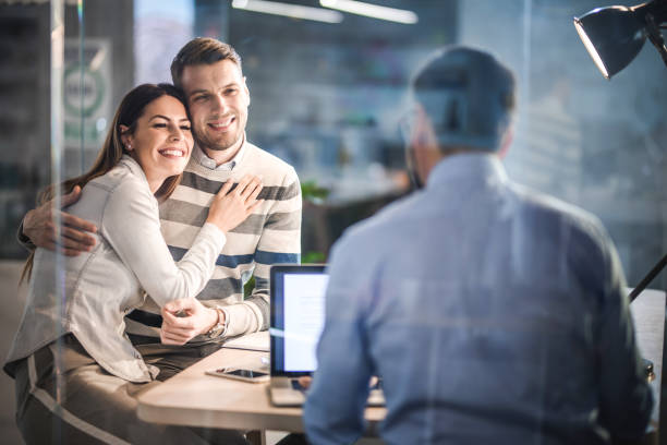 istock Affectionate couple talking to their financial advisor in the office. 1154921142