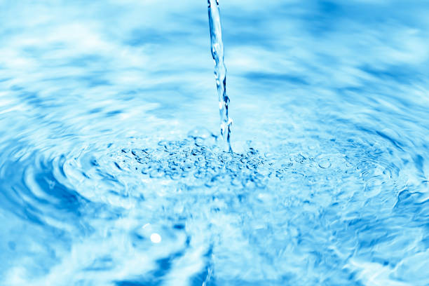 istock Close up of water falling on transparent water surface 1154923091