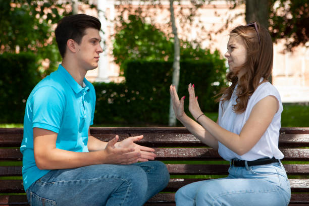 istock Young attractive couple have an argument over something, outdoor shoot 1154923236
