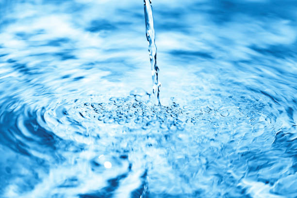 istock Close up of water falling on transparent water surface 1154923238