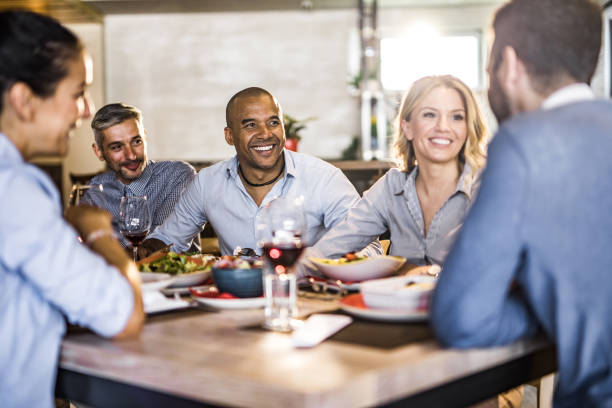 istock Happy business colleagues communicating while enjoying in their lunch in a restaurant. 1154925259