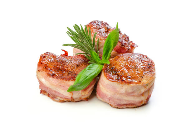 Pork fillet wrapped in bacon, isolated on white background.