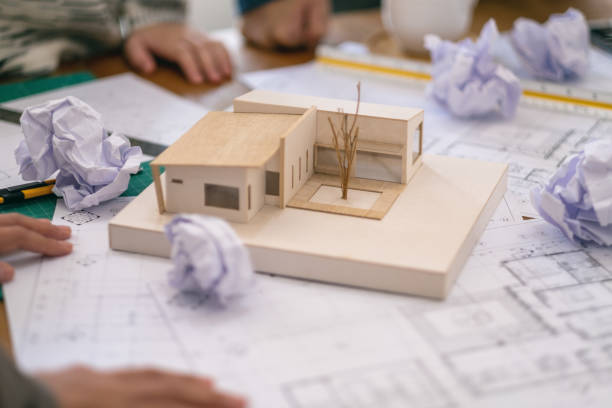 istock an architect feel stressed after working on architecture model together 1154929915