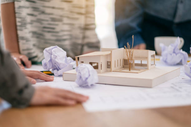 istock an architect feel stressed after working on architecture model together 1154929925