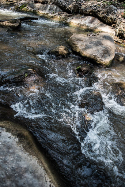 istock Waterfall in the nature and stone background 1154930139