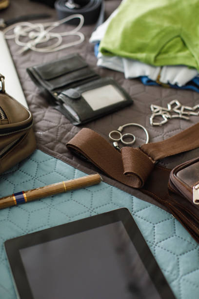 istock Man's accessories on bed prepared for packing 1154930490