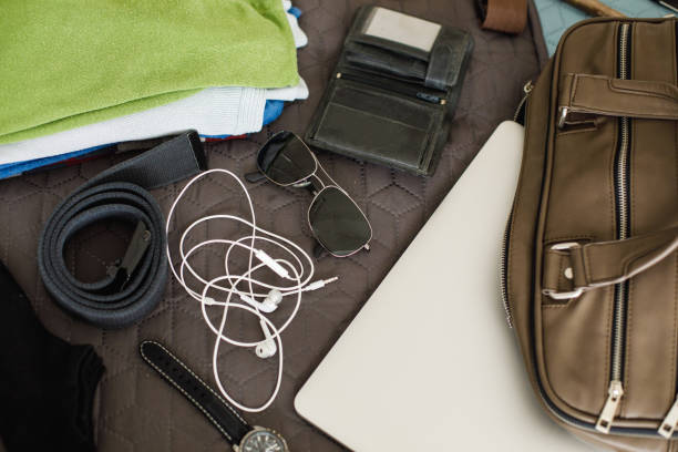 istock Man's travel accessories on bed, flat lay 1154930493