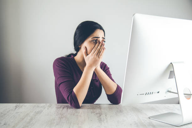 istock surpriesd woman  with computer on desk 1154931788