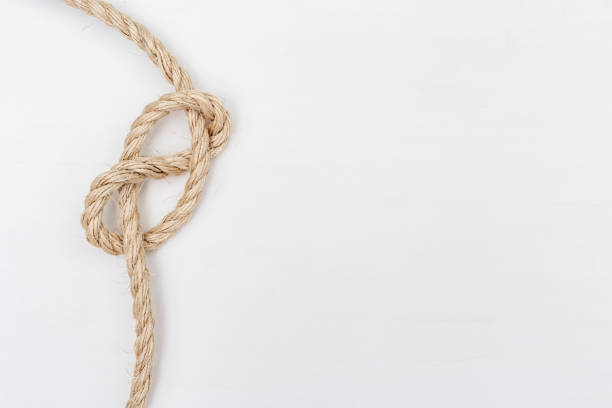 A brown rope is tied to a large bamboo stick.