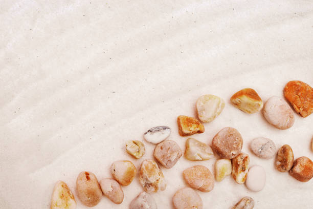 istock Sea pebbles on fine light sand. Sand texture. Natural background. Sandy beach. 1154932481
