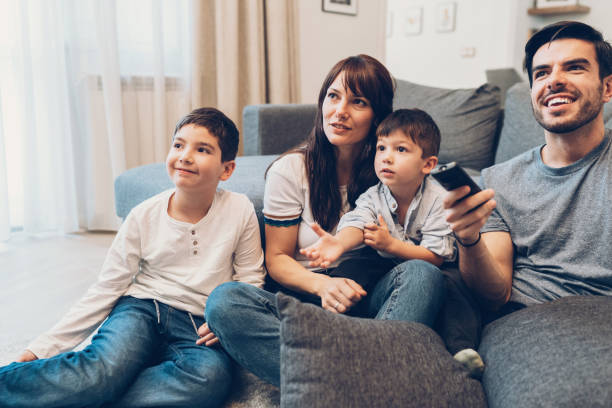 istock Family watching television 1154933818